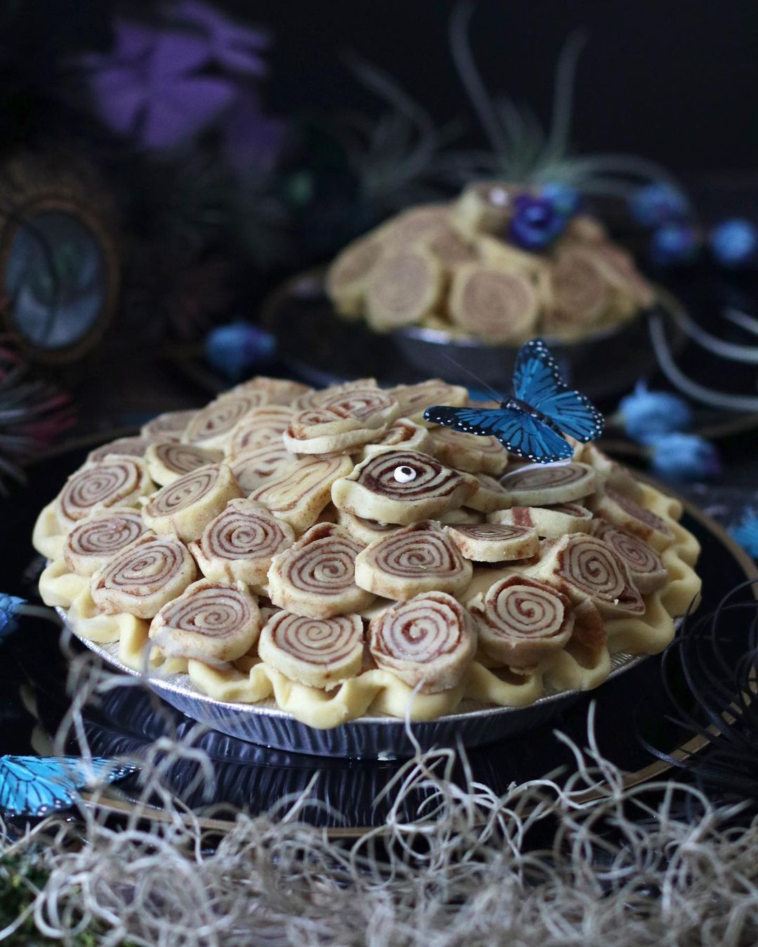 An A La Mode pie decorated with a plastic blue butterfly